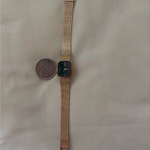 Seiko Gold strap and dark green face with three diamonds